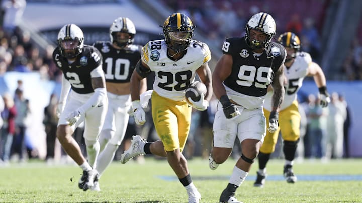 Iowa running back Kamari Moulton runs with the ball in the Hawkeyes’ win over Vanderbilt in the ReliaQuest Bowl. The Big Ten is 7–1 in bowl games this season.