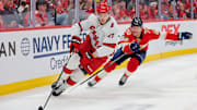 May 26, 2025; Sunrise, Florida, USA; Carolina Hurricanes defenseman Alexander Nikishin (21) controls the puck as Florida Panthers center Jesper Boqvist (70) defends during the second period in game four of the Eastern Conference Final of the 2025 Stanley Cup Playoffs at Amerant Bank Arena. Mandatory Credit: Sam Navarro-Imagn Images