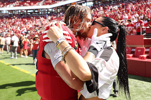 49ers tight end George Kittle kisses wife Claire at the game against the Arizona Cardinals