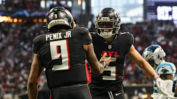 Jan 5, 2025; Atlanta, Georgia, USA; Atlanta Falcons quarterback Michael Penix Jr. (9) celebrates with wide receiver Drake London (5) after a touchdown run against the Carolina Panthers in the second quarter at Mercedes-Benz Stadium. Mandatory Credit: Brett Davis-Imagn Images
