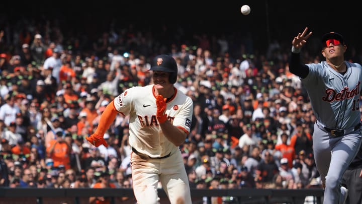 Aug 11, 2024; San Francisco, California, USA; San Francisco Giants third baseman Matt Chapman (26) is caught between Detroit Tigers catcher Dillon Dingler (38) and third baseman Gio Urshela (13) during the eighth inning at Oracle Park. 