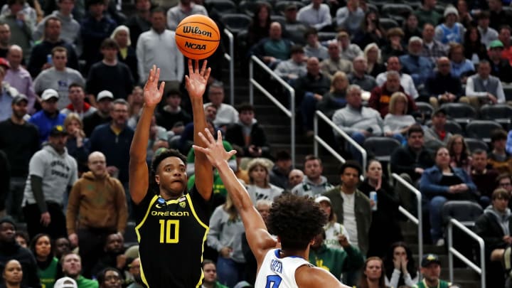 Mar 23, 2024; Pittsburgh, PA, USA; Oregon Ducks forward Kwame Evans Jr. (10) shoots the ball against Creighton Bluejays forward Jasen Green (0) during overtime in the second round of the 2024 NCAA Tournament at PPG Paints Arena. Mandatory Credit: Charles LeClaire-USA TODAY Sports