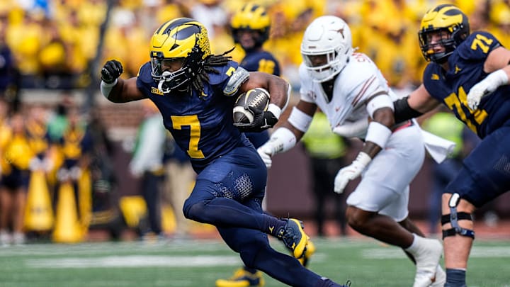 Michigan running back Donovan Edwards (7) runs for a first down against Texas during the first half at Michigan Stadium in Ann Arbor on Saturday, September 7, 2024.