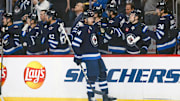 Mar 14, 2025; Winnipeg, Manitoba, CAN;  Winnipeg Jets defenseman Dylan Samberg (54) is congratulated by his team mates on his goal against the Dallas Stars during the second period at Canada Life Centre. Mandatory Credit: Terrence Lee-Imagn Images