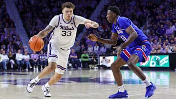 Feb 8, 2025; Manhattan, Kansas, USA; Kansas State Wildcats forward Coleman Hawkins (33) drives to the basket against Kansas Jayhawks forward Flory Bidunga (40) during the first half at Bramlage Coliseum. Mandatory Credit: Scott Sewell-Imagn Images