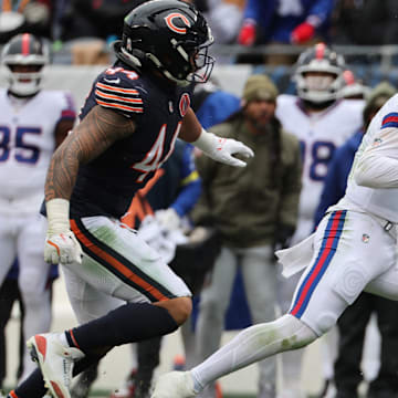 Jaxson Dart takes off with the football on a planned QB run as Noah Sewell gives chase in Sunday's 24-20 Bears win.