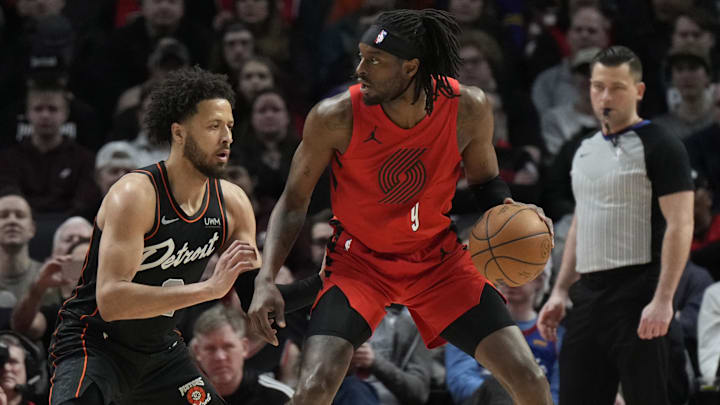  Portland Trail Blazers small forward Jerami Grant (9) controls the ball as Detroit Pistons point guard Cade Cunningham (2, left) defends during the first half at Moda Center.