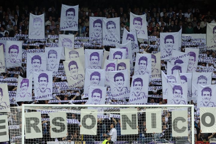 Real Madrid supporters hold up portraits