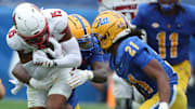 Sep 27, 2025; Pittsburgh, Pennsylvania, USA;  Louisville Cardinals wide receiver Antonio Meeks (15) is tackled after a catch by Pittsburgh Panthers linebacker Rasheem Biles (3) and defensive back Shadarian Harrison (21) during the third quarter at Acrisure Stadium. Mandatory Credit: Charles LeClaire-Imagn Images