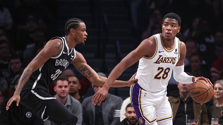 Mar 31, 2024; Brooklyn, New York, USA; Los Angeles Lakers forward Rui Hachimura (28) dribbles against Brooklyn Nets center Nic Claxton (33) during the first half at Barclays Center. Mandatory Credit: Vincent Carchietta-Imagn Images