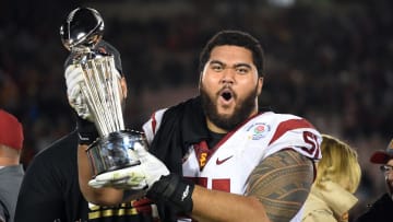 Jan 2, 2017; Pasadena, CA, USA; USC Trojans guard Damien Mama (51) celebrates on the podium with the Rose Bowl trophy after defeating the Penn State Nittany Lions in the 2017 Rose Bowl game at Rose Bowl. Mandatory Credit: Jayne Kamin-Oncea-USA TODAY Sports