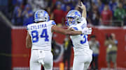 Nov 10, 2024; Houston, Texas, USA; Detroit Lions place kicker Jake Bates (39) celebrates with tight end Shane Zylstra (84) after kicking a field goal with time expiring to give the Lions a win over the Houston Texans at NRG Stadium. Mandatory Credit: Troy Taormina-Imagn Images