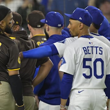 San Diego Padres right fielder Fernando Tatis Jr. (23) and Los Angeles Dodgers shortstop Mookie Betts (50) engage on the field after benches cleared in the eighth inning at Dodger Stadium on June 19.