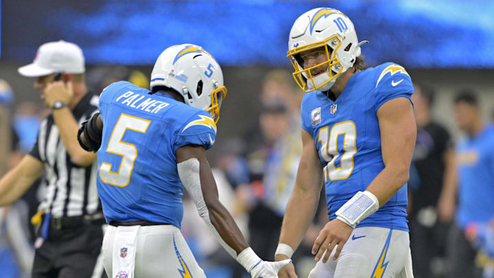 Oct 27, 2024; Inglewood, California, USA; Los Angeles Chargers quarterback Justin Herbert (10) congratulates wide receiver Joshua Palmer (5) after a complete pass against the New Orleans Saints in the second half at SoFi Stadium. Mandatory Credit: Jayne Kamin-Oncea-Imagn Images