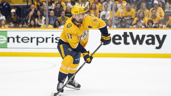 Apr 28, 2024; Nashville, Tennessee, USA; in game four of the first round of the 2024 Stanley Cup Playoffs at Nashville Predators defenseman Dante Fabbro (57) clears the puck against the Vancouver Canucks during the first period Bridgestone Arena. Mandatory Credit: Steve Roberts-USA TODAY Sports