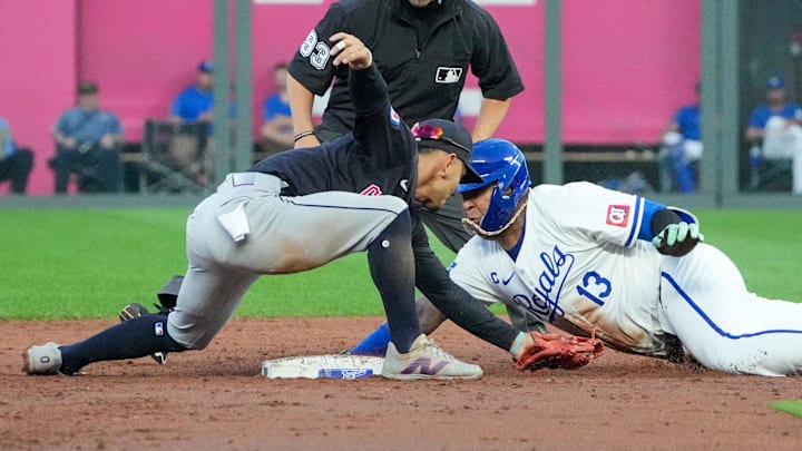 Sep 4, 2024; Kansas City, Missouri, USA; Cleveland Guardians second baseman Andrés Giménez (0) misses the tag as Kansas City Royals first baseman Salvador Perez (13) reaches second on a double in the third inning at Kauffman Stadium. Mandatory Credit: Denny Medley-Imagn Images