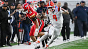 Oct 14, 2023; College Park, Maryland, USA;  Illinois Fighting Illini quarterback Luke Altmyer (9) cuts by Maryland Terrapins linebacker Caleb Wheatland (44) for a first down during the second half at SECU Stadium. Mandatory Credit: Tommy Gilligan-Imagn Images