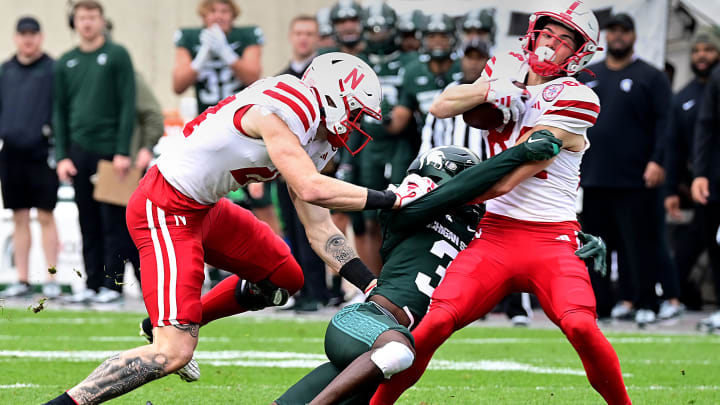 Nov 4, 2023; East Lansing, Michigan, USA;  Michigan State Spartans defensive back Caleb Coley (3) tackles Nebraska Cornhuskers wide receiver Alex Bullock (84) in spite of  tight end Thomas Fidone II (24) at Spartan Stadium. Mandatory Credit: Dale Young-USA TODAY Sports