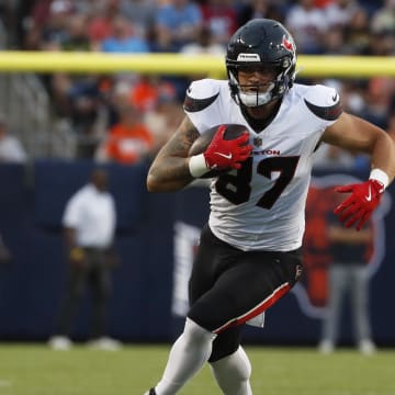 Aug 1, 2024; Canton, Ohio, USA;  Houston Texans tight end Cade Stover (87) runs after a catch against the Chicago Bears during the first quarter at Tom Benson Hall of Fame Stadium. Mandatory Credit: Charles LeClaire-USA TODAY Sports