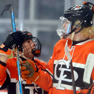 Cathedral Prep's Ethan Cunningham, center, along with Chris Bruschi, left, and Tucker Kinnear, right, celebrates his goal in the Penguins Cup Class 2A final Tuesday night at the UPMC Lemieux Complex. Cunningham scored a hat trick, including an overtime game-winner, to lift the Ramblers to their fifth title in program history.