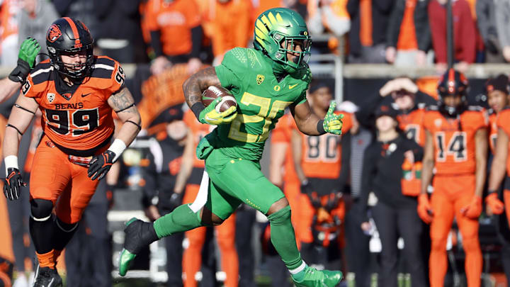 Nov 26, 2022; Corvallis, Oregon, USA; Oregon Ducks running back Jordan James (20) runs with the ball during the first half against the Oregon State Beavers at Reser Stadium. Mandatory Credit: Soobum Im-Imagn Images