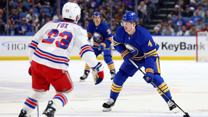 Dec 11, 2024; Buffalo, New York, USA;  Buffalo Sabres defenseman Bowen Byram (4) looks to make a pass during the second period against the New York Rangers at KeyBank Center. Mandatory Credit: Timothy T. Ludwig-Imagn Images