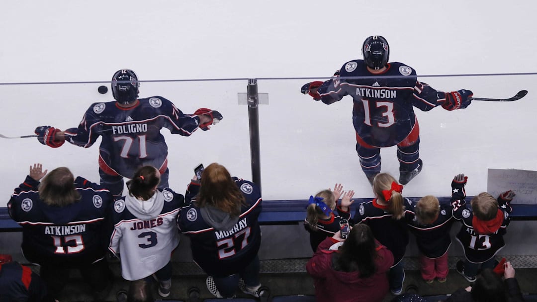 Fans gather to watch Nick Foligno and Cam Atkinson warm up before a game in Nationwide Arena on Jan. 18.