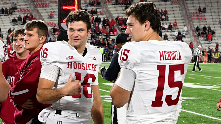 Indiana QBs Alberto Mendoza, left, and Fernando Mendoza talk on the sideline