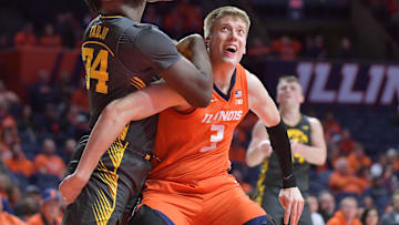 Feb 25, 2025; Champaign, Illinois, USA;  Iowa Hawkeyes forward Chris Tadjo (34) and Illinois Fighting Illini forward Ben Humrichous (3) battle for position during the second half at State Farm Center. Mandatory Credit: Ron Johnson-Imagn Images