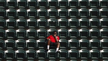 Jul 6, 2025; Minneapolis, Minnesota, USA; A Minnesota Twins fan watches as they play the Tampa Bay Rays in the 10th inning at Target Field. Mandatory Credit: Bruce Kluckhohn-Imagn Images