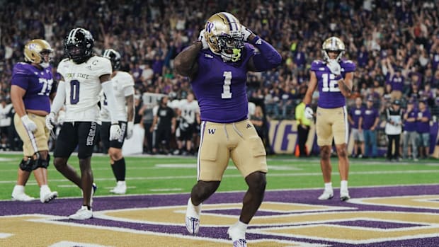 Jonah Coleman celebrates a touchdown run against Weber State.