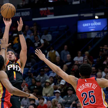 Apr 1, 2024; New Orleans, Louisiana, USA; Phoenix Suns guard Bradley Beal (3) shoots a three point basket against New Orleans Pelicans forward Herbert Jones (5) and New Orleans Pelicans guard Trey Murphy III (25) during the first half at Smoothie King Center.