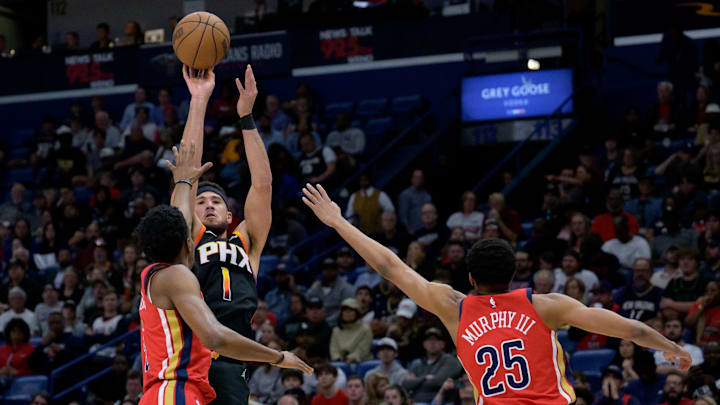 Apr 1, 2024; New Orleans, Louisiana, USA; Phoenix Suns guard Bradley Beal (3) shoots a three point basket against New Orleans Pelicans forward Herbert Jones (5) and New Orleans Pelicans guard Trey Murphy III (25) during the first half at Smoothie King Center.