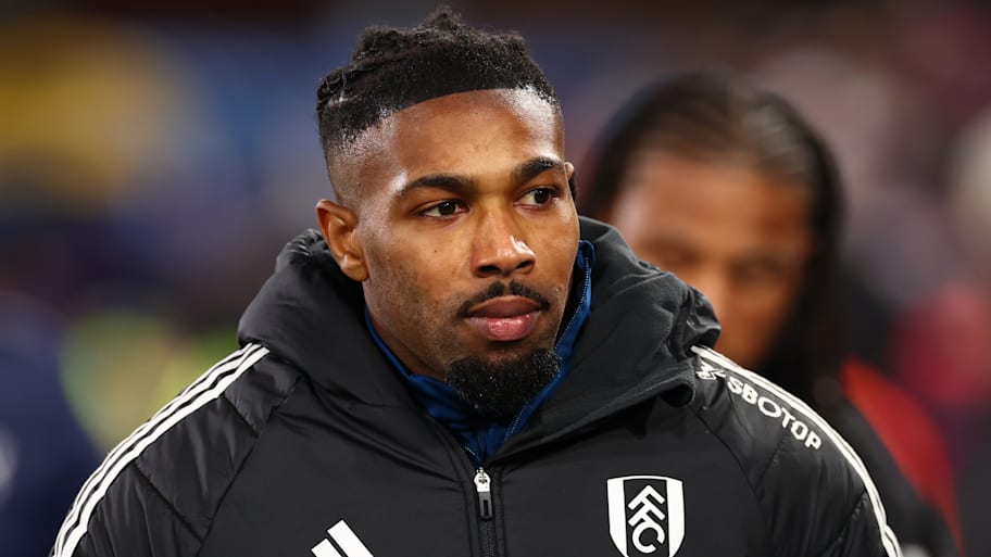 Adama Traore in a big coat.