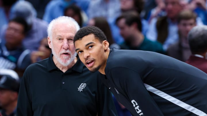 Dec 23, 2023; Dallas, Texas, USA; San Antonio Spurs head coach Gregg Popovich speaks with San Antonio Spurs center Victor Wembanyama (1) before the game against the Dallas Mavericks at American Airlines Center. Mandatory Credit: Kevin Jairaj-USA TODAY Sports