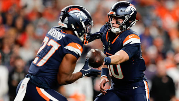 Denver Broncos quarterback Bo Nix (10) hands the ball off to Denver Broncos running back J.K. Dobbins (27).