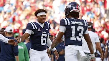 Nov 8, 2025; Oxford, Mississippi, USA; Mississippi Rebels quarterback Trinidad Chambliss (6) reacts with quarterback Austin Simmons (13) during the fourth quarter against The Citadel Bulldogs at Vaught-Hemingway Stadium. Mandatory Credit: Petre Thomas-Imagn Images