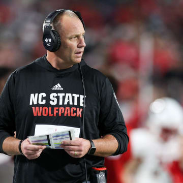 Dec 28, 2023; Orlando, FL, USA;  North Carolina State Wolfpack head coach Dave Doeren looks on from the sidelines during the Pop-Tarts bowl against Kansas State Wildcats in the fourth quarter at Camping World Stadium. Mandatory Credit: Nathan Ray Seebeck-USA TODAY Sports