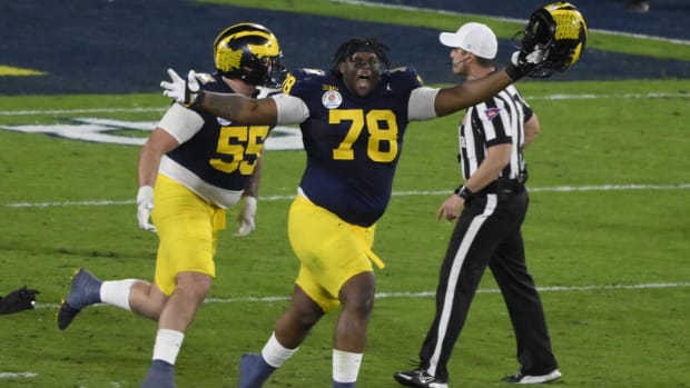 Michigan Wolverines defensive lineman Kenneth Grant celebrates a victory in a college football game in the Big Ten.