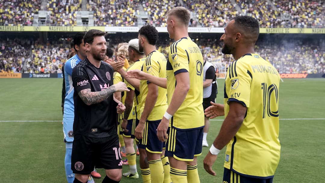 Inter Miami CF captain Lionel Messi greets Nashville SC attackers Sam Surridge and Hany Mukhtar before a match at Geodis Park earlier this year.