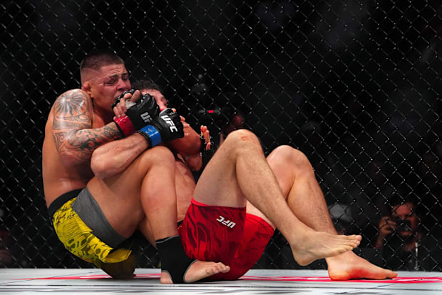 Brunno Ferreira (red gloves) fights Armen Petrosyan (blue gloves) during UFC 313 at T-Mobile Arena. 
