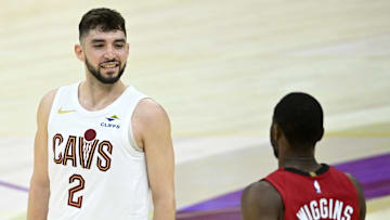 Apr 20, 2025; Cleveland, Ohio, USA; Cleveland Cavaliers guard Ty Jerome (2) reacts beside Miami Heat forward Andrew Wiggins (22) after making a three-point basket in the fourth quarter at Rocket Arena. Mandatory Credit: David Richard-Imagn Images