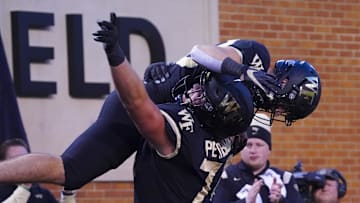 Oct 30, 2021; Winston-Salem, North Carolina, USA; Wake Forest Demon Deacons wide receiver Taylor Morin (83) celebrates with offensive lineman Luke Petitbon (74) after touchdown catch against the Duke Duke Blue Devils during the second half at Truist Field. Mandatory Credit: James Guillory-Imagn Images