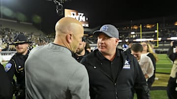 Vanderbilt's Clark Lea, shown here with Kentucky's Mark Stoops, is reportedly "in a really good position" to take the Penn State job.