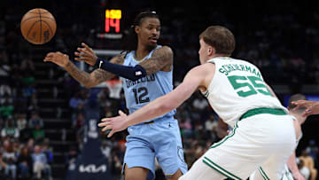 Mar 31, 2025; Memphis, Tennessee, USA; Memphis Grizzlies guard Ja Morant (12) passes the ball as Boston Celtics forward Baylor Scheierman (55) defends during the third quarter at FedExForum. Mandatory Credit: Petre Thomas-Imagn Images