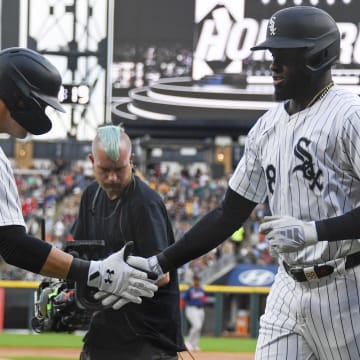 Chicago White Sox outfielder Luis Robert Jr. (88) high fives outfielder Gavin Sheets (32) after he hits a home run against the Boston Red Sox during the first inning at Guaranteed Rate Field on June 7.