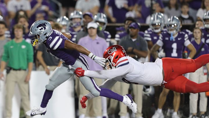 Kansas State Wildcats running back Dylan Edwards (3) leaps away from Arizona Wildcats linebacker Sterling Lane II (8) during the third quarter of the game at Bill Snyder Family Stadium on Friday, September 13, 2024.