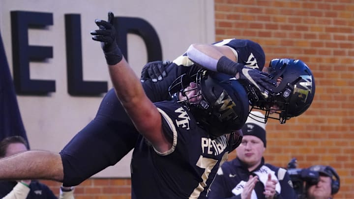 Oct 30, 2021; Winston-Salem, North Carolina, USA; Wake Forest Demon Deacons wide receiver Taylor Morin (83) celebrates with offensive lineman Luke Petitbon (74) after touchdown catch against the Duke Duke Blue Devils during the second half at Truist Field. Mandatory Credit: James Guillory-Imagn Images