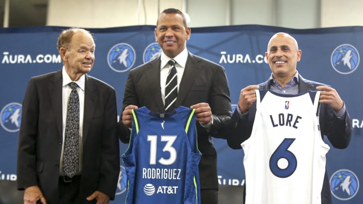 Sep 27, 2021; Minneapolis, MN, USA; Current owner Glen Taylor and limited partners and alt-governors for the Minnesota Timberwolves Alex Rodriguez and Mark Lore hold up jerseys after answering questions at a press conference at media day. Mandatory Credit: Bruce Kluckhohn-USA TODAY Sports