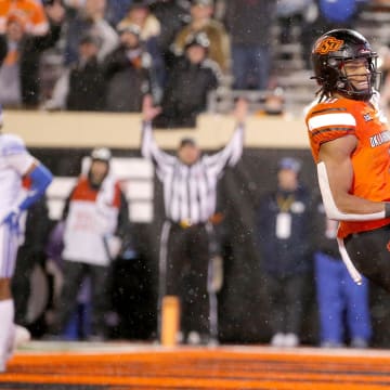 Nov 25, 2023; Stillwater, Oklahoma, USA;  Oklahoma State's Ollie Gordon II (0) scores a touchdown against BYU in the first overtime at Boone Pickens Stadium. Mandatory Credit: Sarah Phipps-USA TODAY Sports
